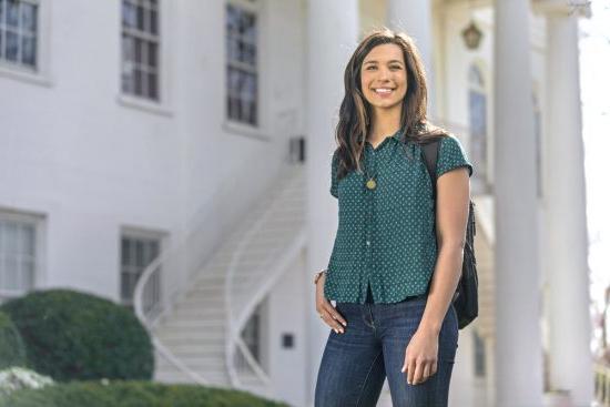 A University of Montevallo student poses for a photograph in front of Reynolds Hall.